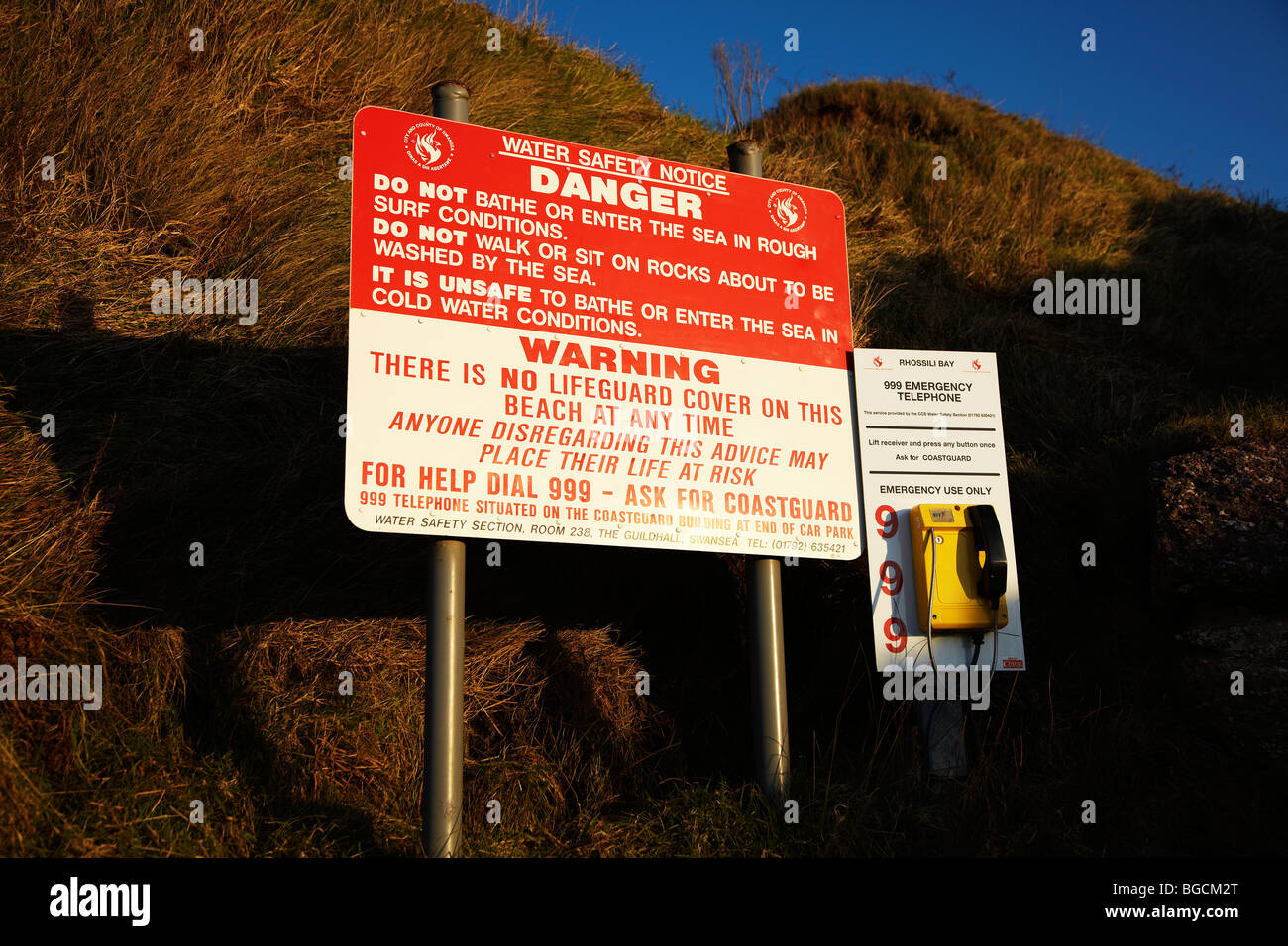 Danger Notice and Coastguard Telephone, Rhossili Bay, Gower, South Wales, UK Stock Photo