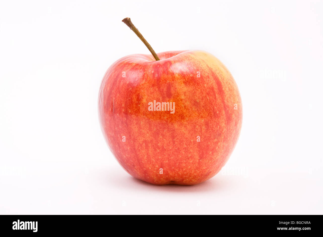 Golden red apple against white background. A jonagold cultivated from the Golden delicious. Stock Photo