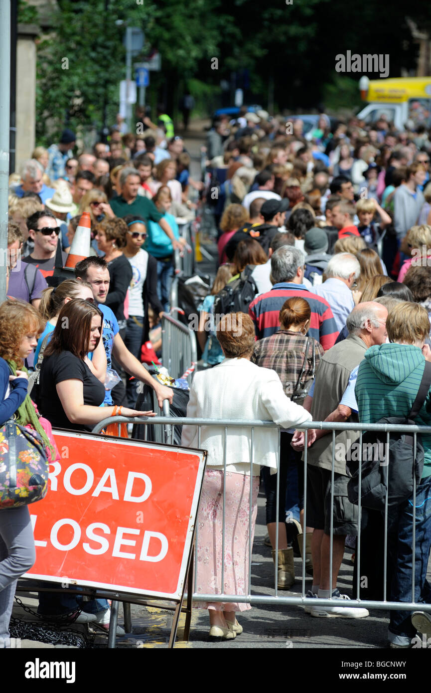 Road closed for crowds queuing on street, contained with barricades, UK Stock Photo