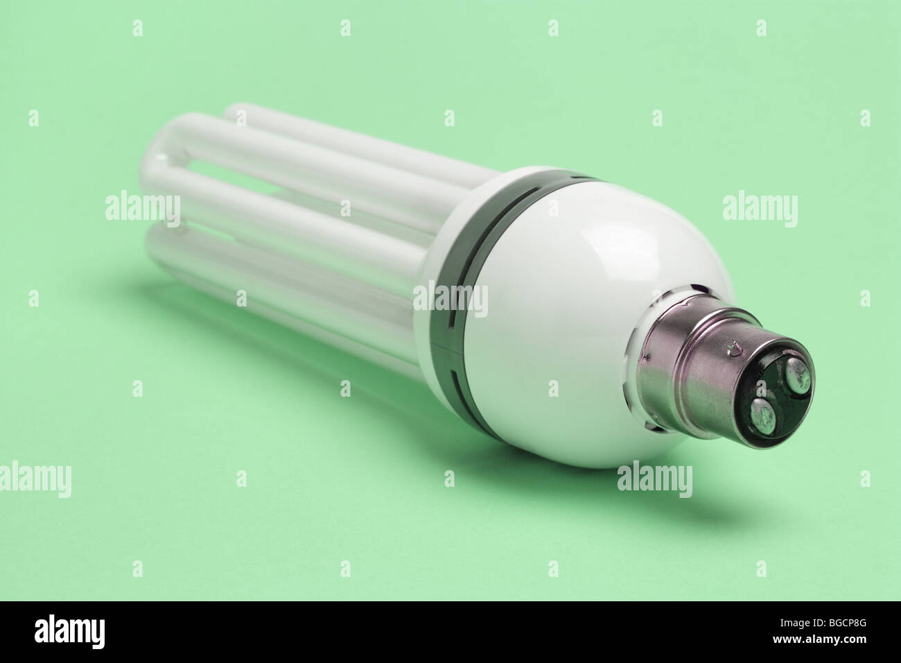 Energy saving light bulb on seamless green background Stock Photo - Alamy