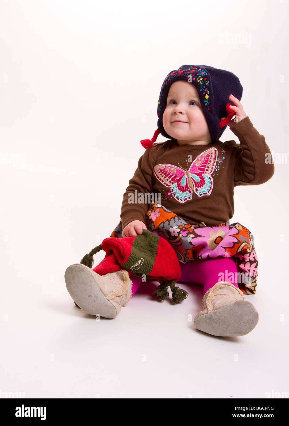 1 year old little girl wearing winter hat isolated on white Stock Photo