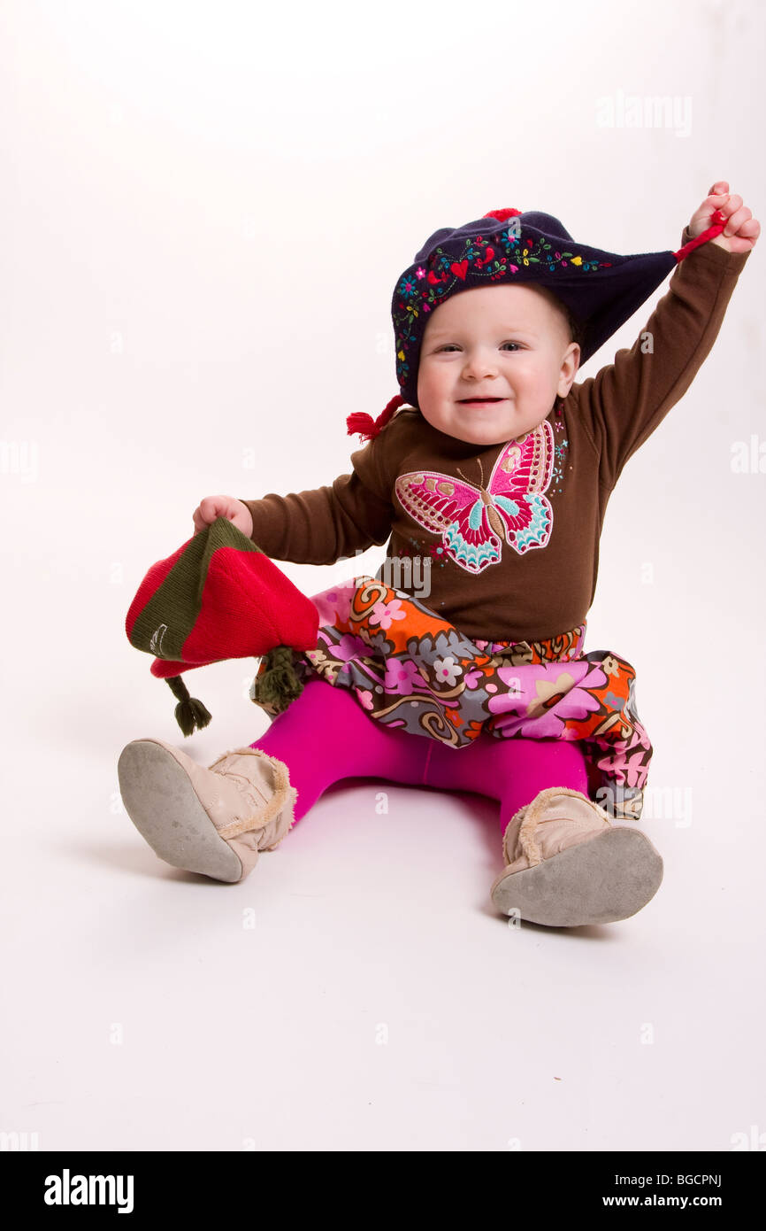 1 year old little girl wearing winter hat isolated on white Stock Photo