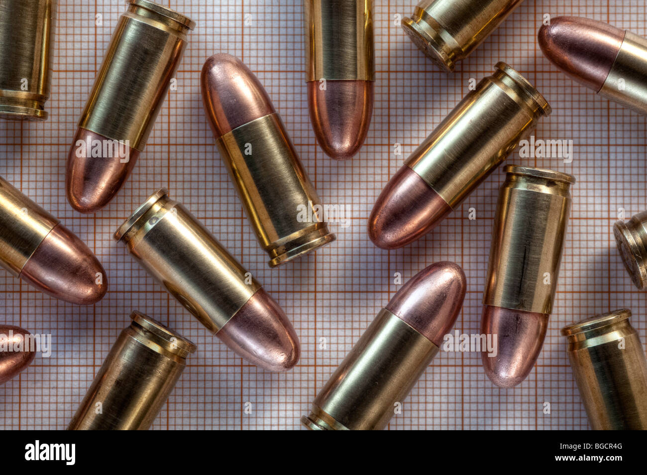 9mm cartridges on 1mm square graph paper Stock Photo
