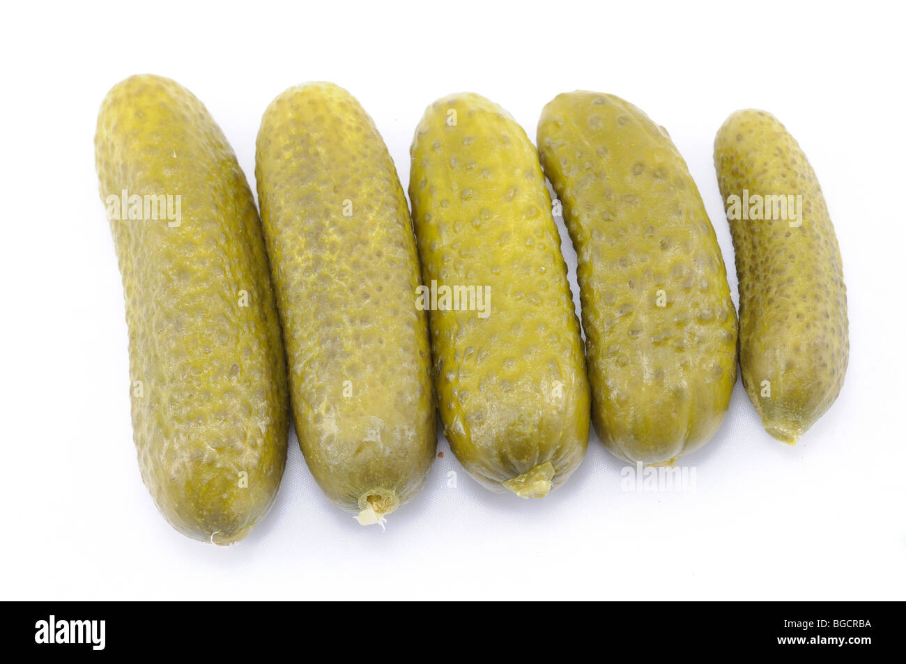 Salty pickled cucumbers isolated over white Stock Photo