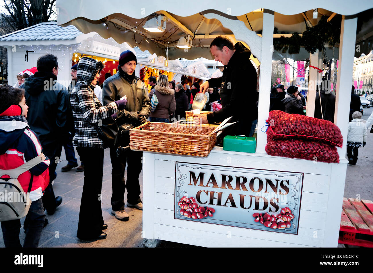 Paris, France, Crowd People, Christmas Food Shopping, Couple Buying Roasted Chestnuts at Traditional French Market, Street Vendor Stock Photo