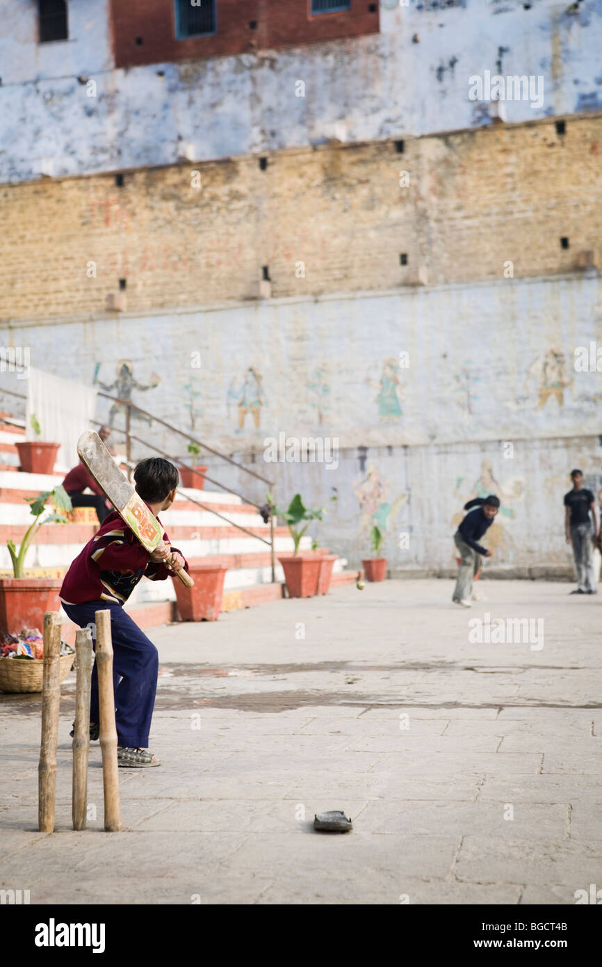 Cricket is the national sport of India, and is played even on the banks of holy Ganges River. Stock Photo
