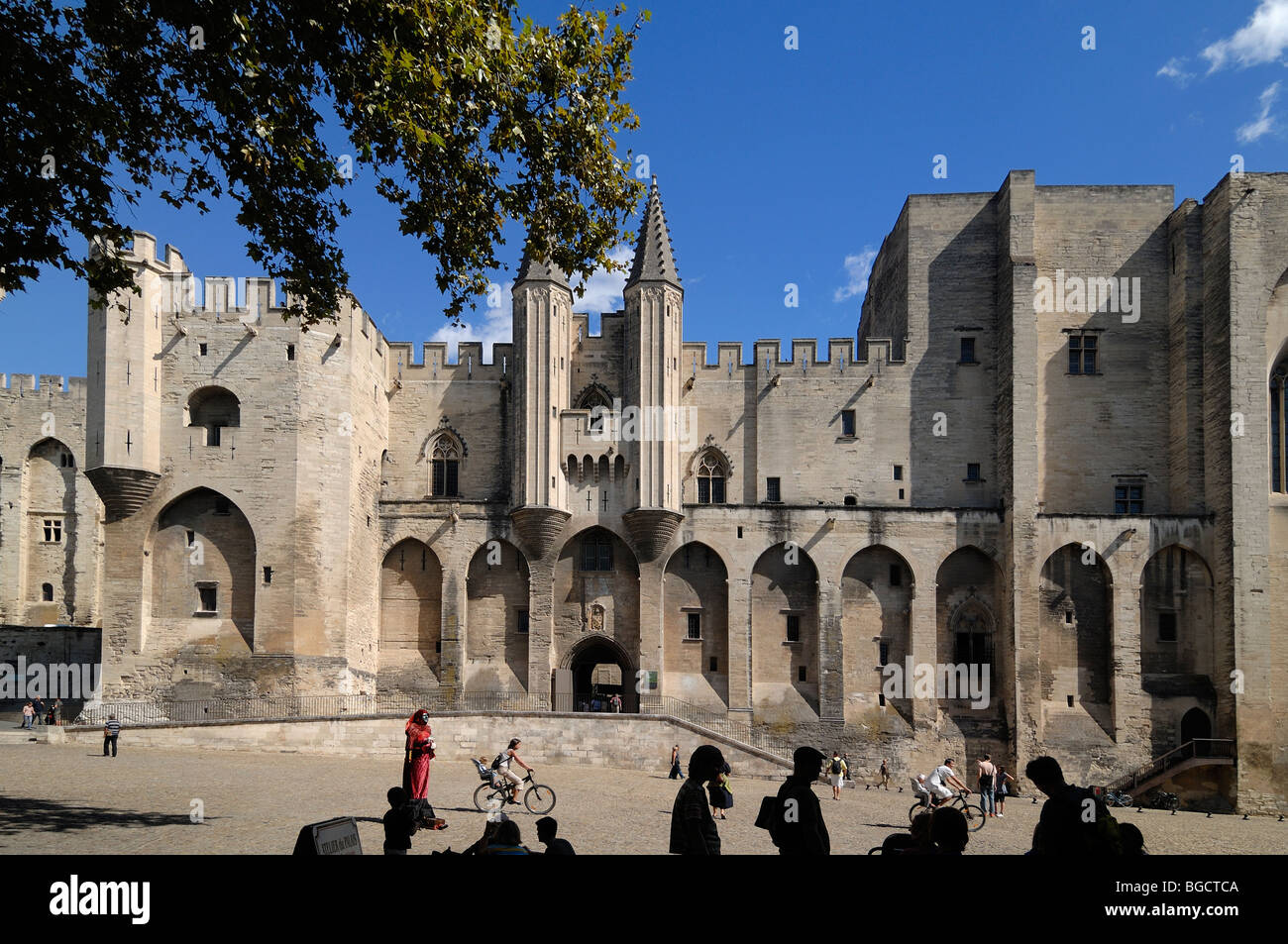 Tourists Outside the Palais des Papes or Popes Palace, Main Entrance or West Facade & Place du Palais, Avignon, Vaucluse, Provence, France Stock Photo