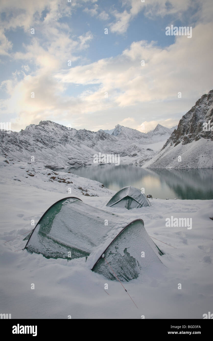 Tents in the snow, Ala Kol Pass, Kyrgyzstan. Stock Photo