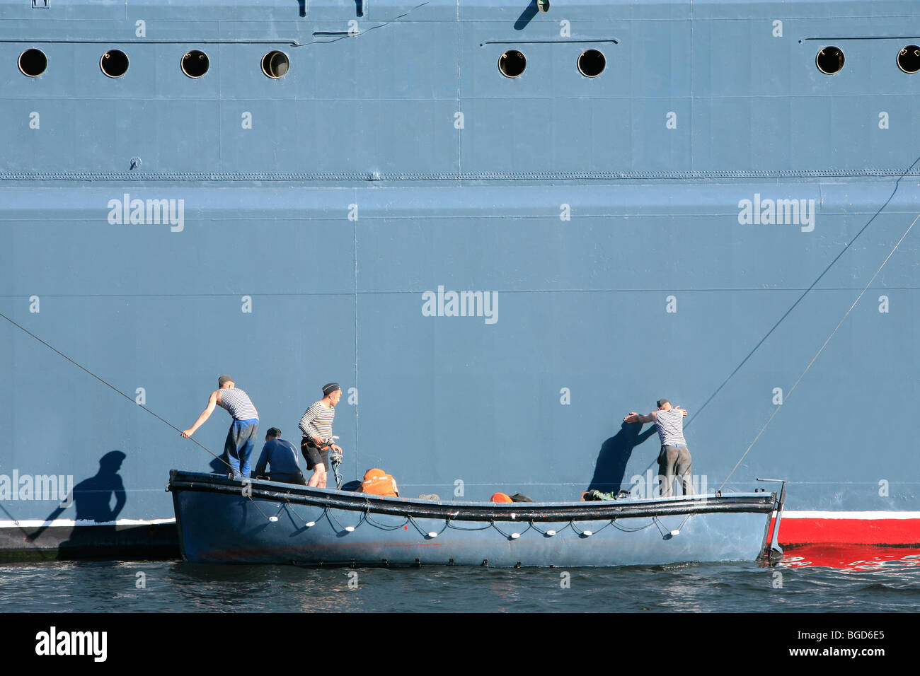 3 Russian sailors painting the Corvette Steregushchy during a naval parade in Saint Petersburg, Russia Stock Photo