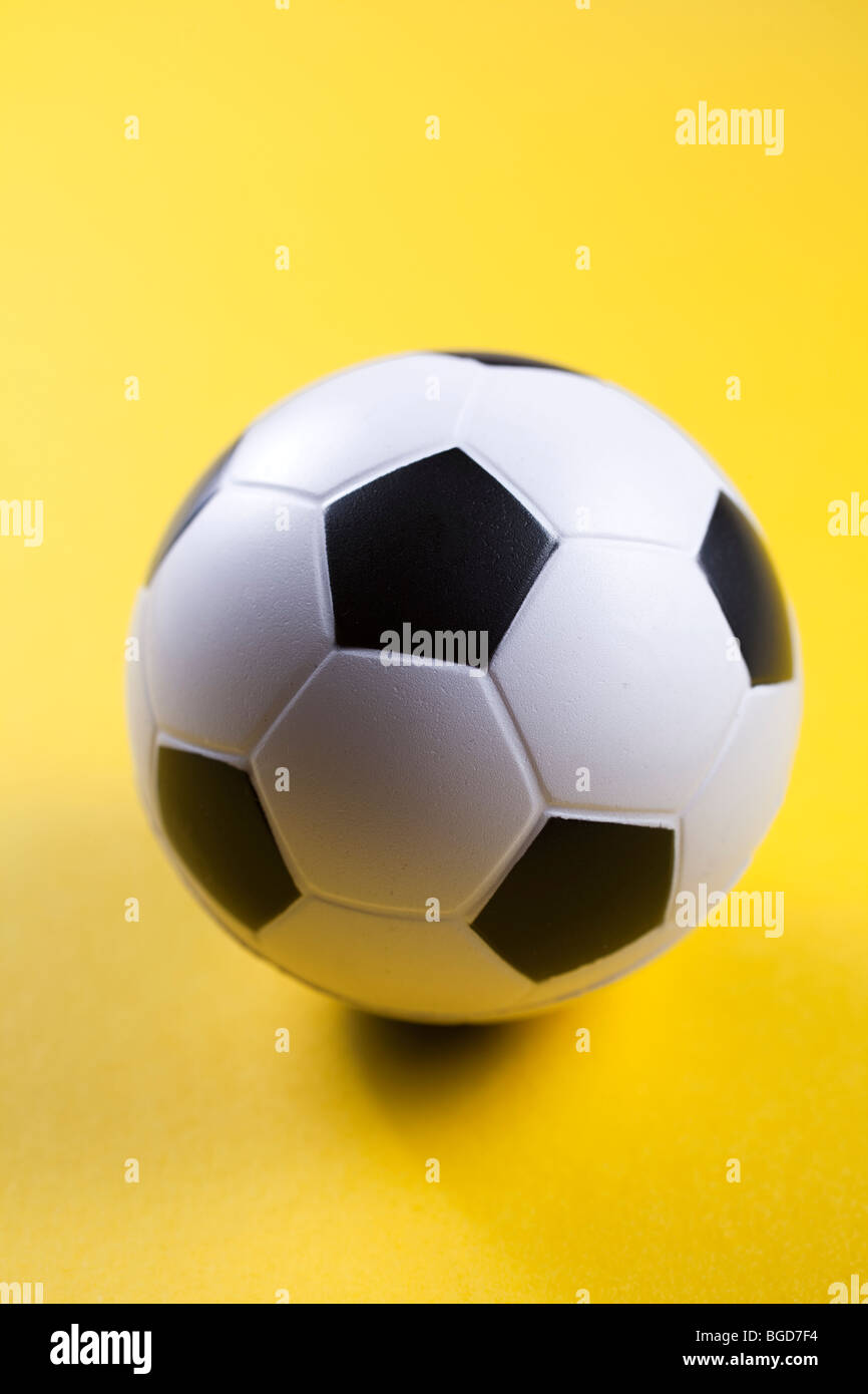 BLACK AND WHITE SOCCER BALL TOY ON YELLOW BACKGROUND Stock Photo Alamy
