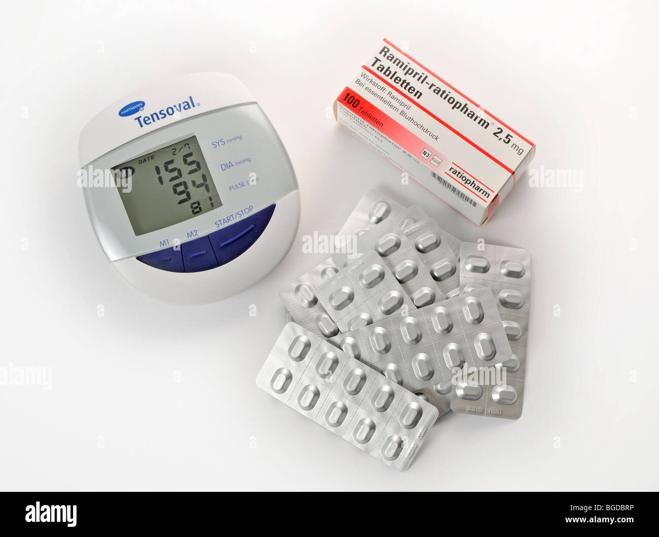 Antihypertensive tablets in a blister pack and phygmomanometer blood pressure meter, showing high blood pressure Stock Photo
