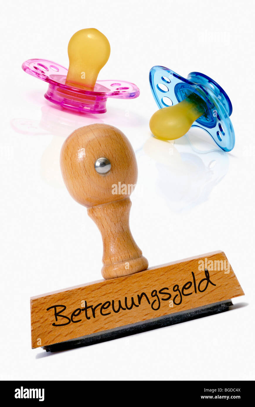 Pacifier and stamp with the word Betreuungsgeld, child care cash benefit Stock Photo
