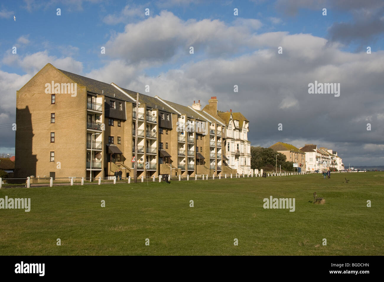 modern low rise brick flats sea view grass verge Stock Photo