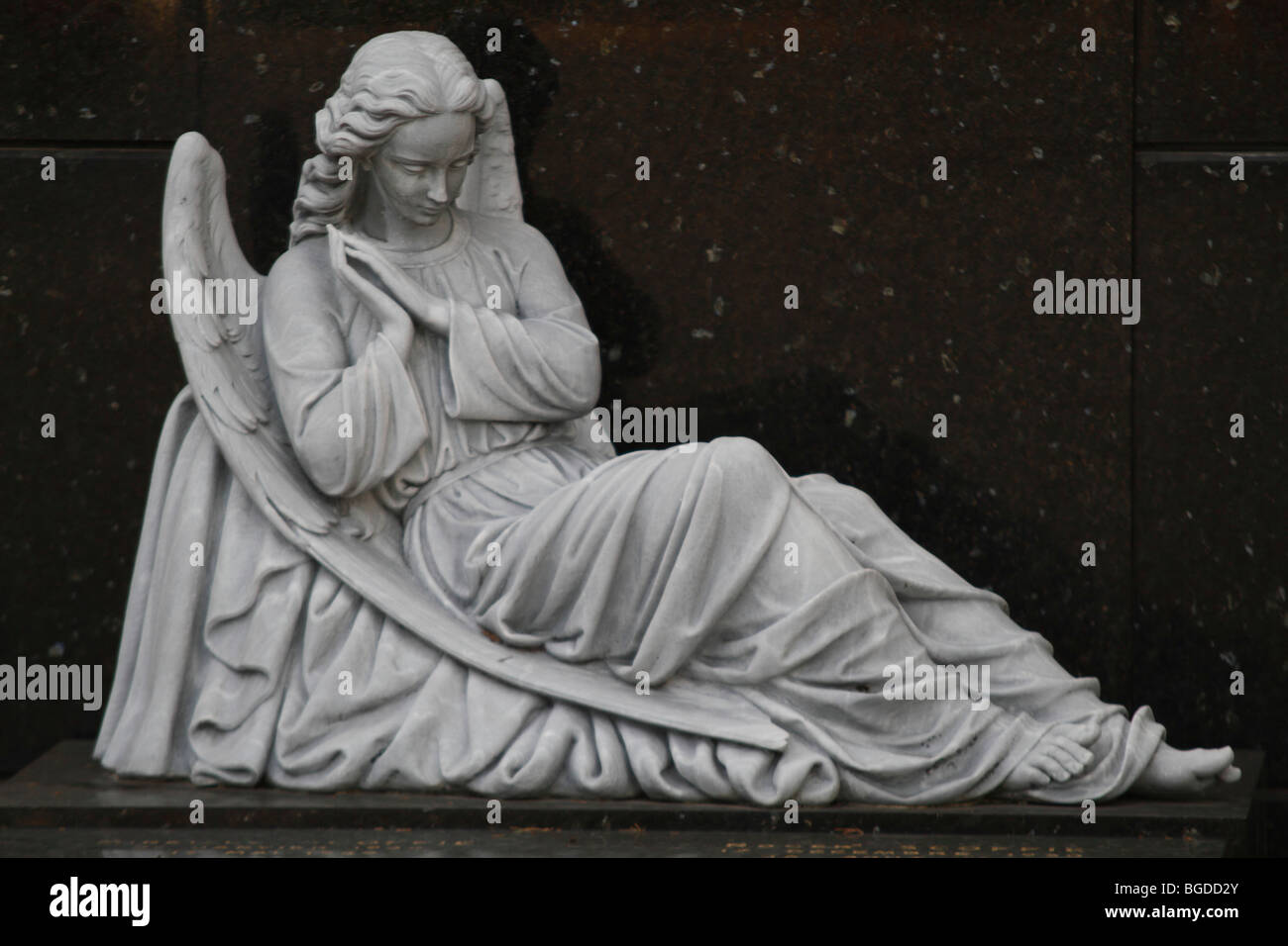 Seated praying angel in front of black marble, tomb, Cimetière du Vieux Château cemetery, Nice, Alpes Maritimes, Région Provenc Stock Photo