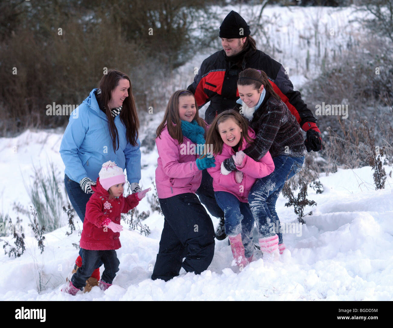Family enjoying the snow together Stock Photo - Alamy