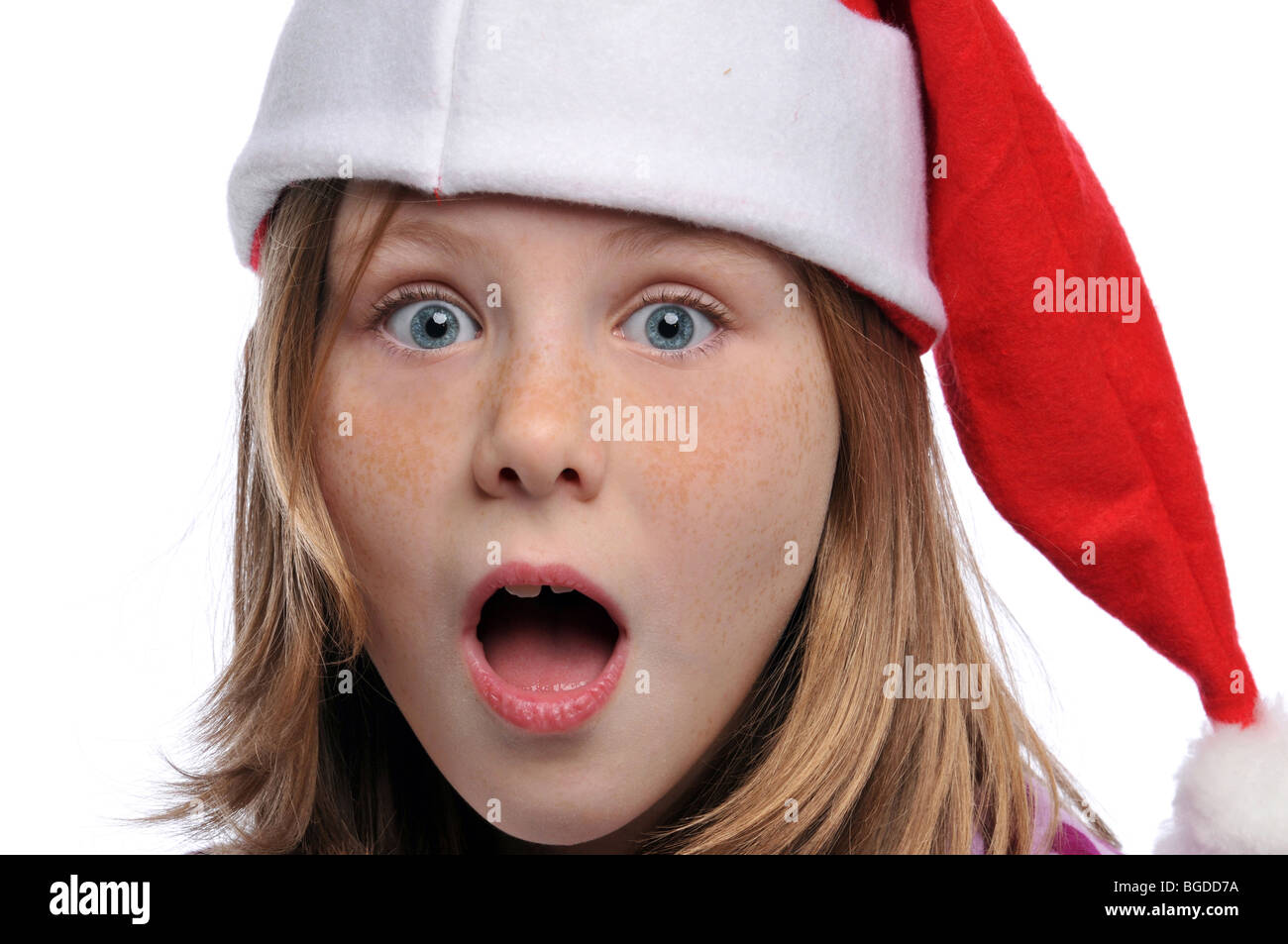 Titlle girl's portrait wearing a Santa's hat isolated on a white background Stock Photo