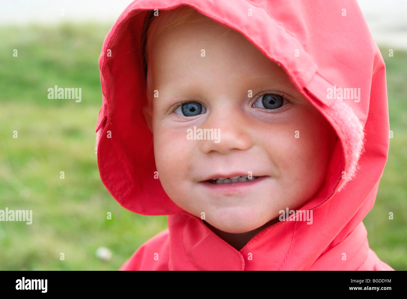 Portrait of a little girl with a red rain jacket Stock Photo