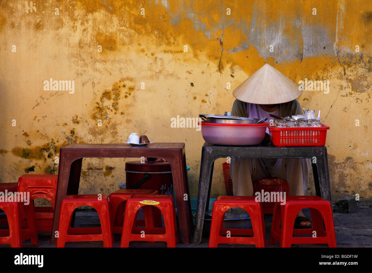 Vietnamese woman waiting for customers at her streetside stall, Hoi An, Vietnam, Southeast Asia Stock Photo