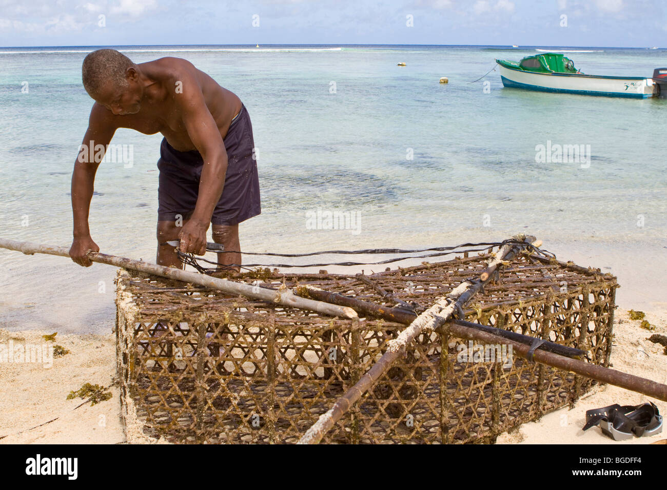 Fisherman, Creole, with bow net, Anse Forbans, island of Mahe, Seychelles, Africa, Indian Ocean Stock Photo