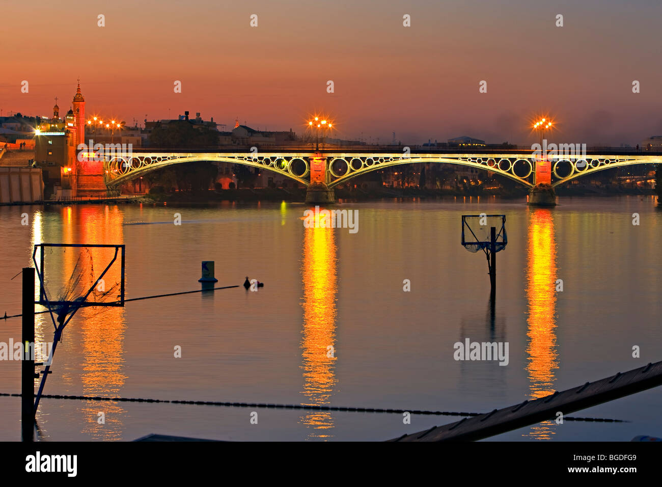 Puente de Isabel II (bridge) across the Rio Guadalquivir (River) at dusk, City of Sevilla (Seville), Province of Sevilla, Andalu Stock Photo