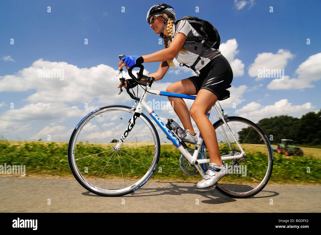 Young woman riding a bicycle, Bavaria, Germany, Europe Stock Photo