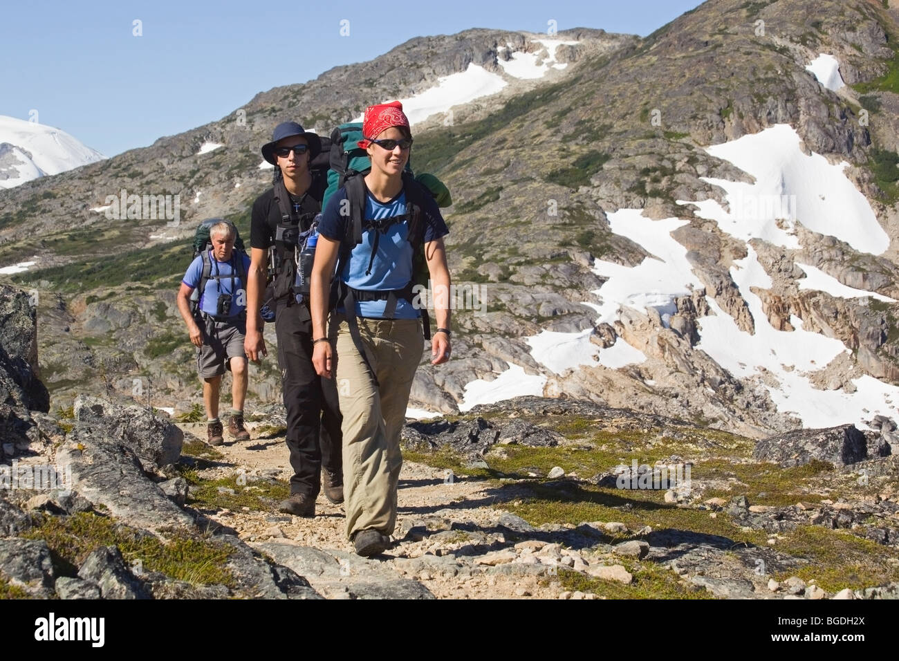 Group of young hikers hiking, backpacking, backpack, historic Chilkoot