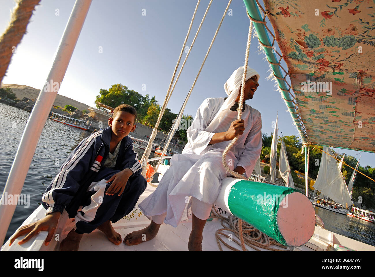 ASWAN, EGYPT. A Nubian boatman and his son on a Nile felucca. 2009. Stock Photo