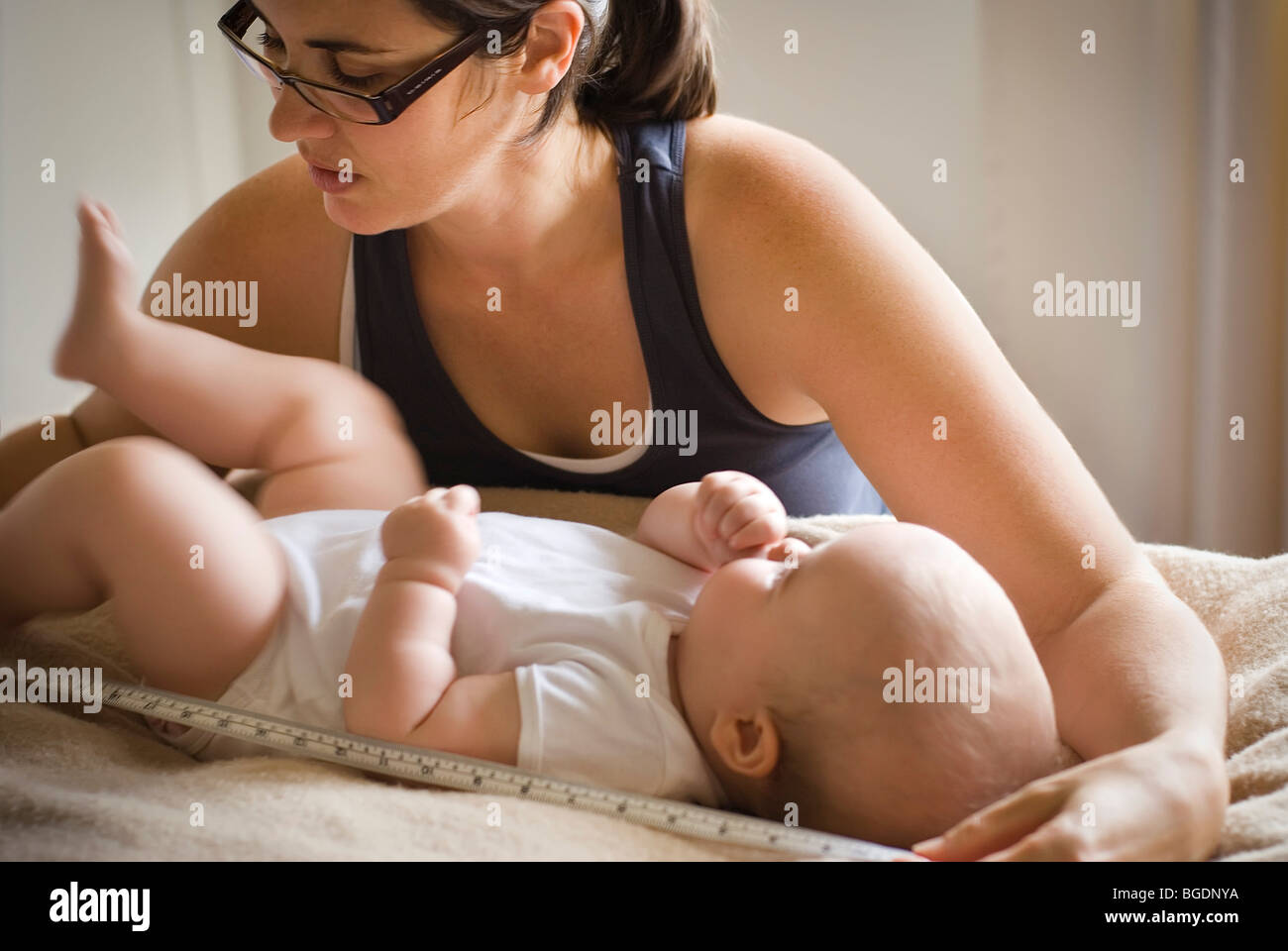 Mother measuring baby Stock Photo