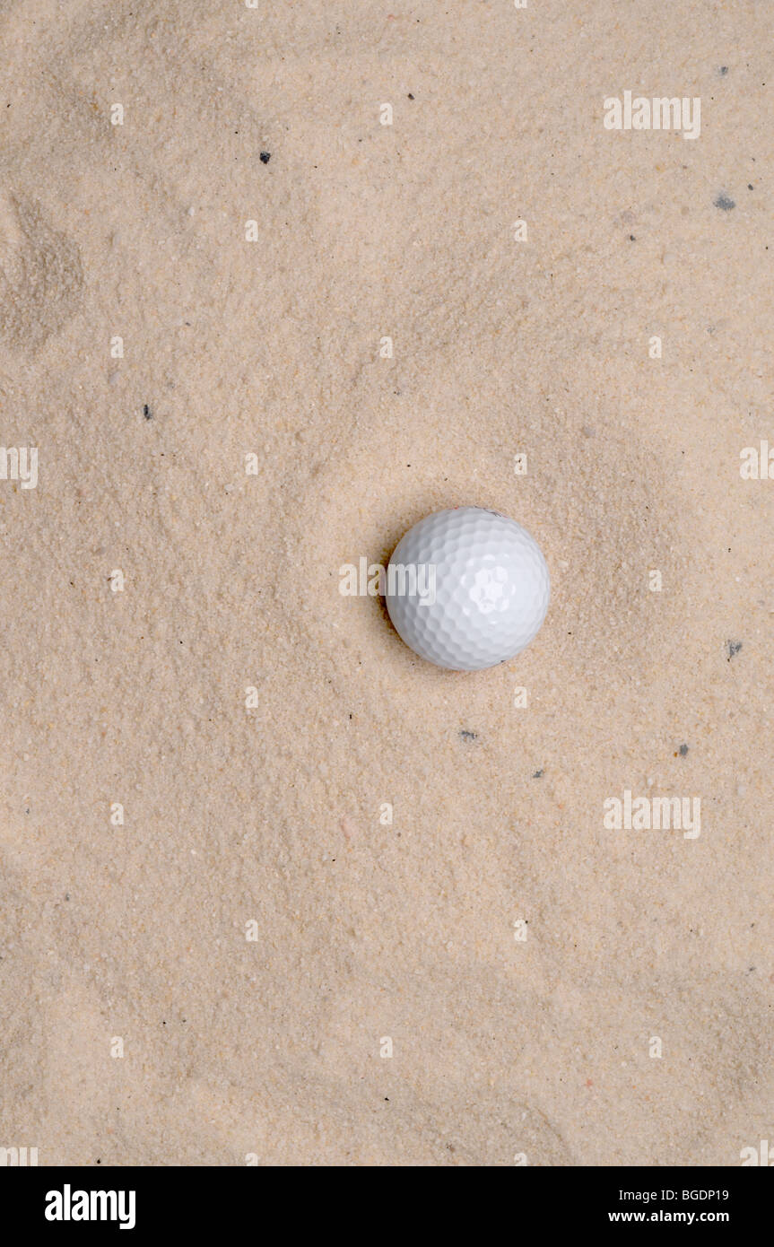 a golf ball in a sand trap Stock Photo