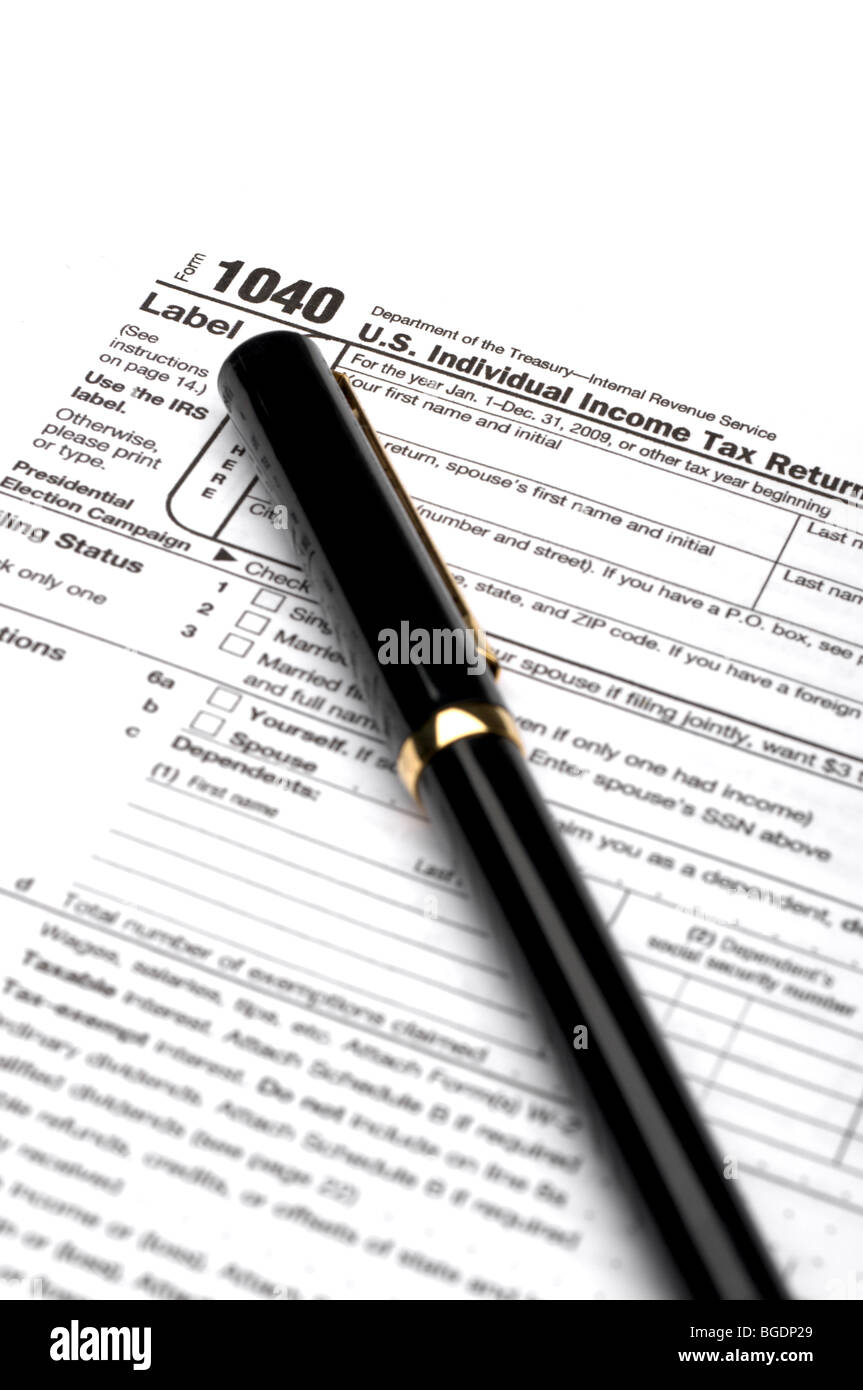 1040 income tax form and a black pen Stock Photo