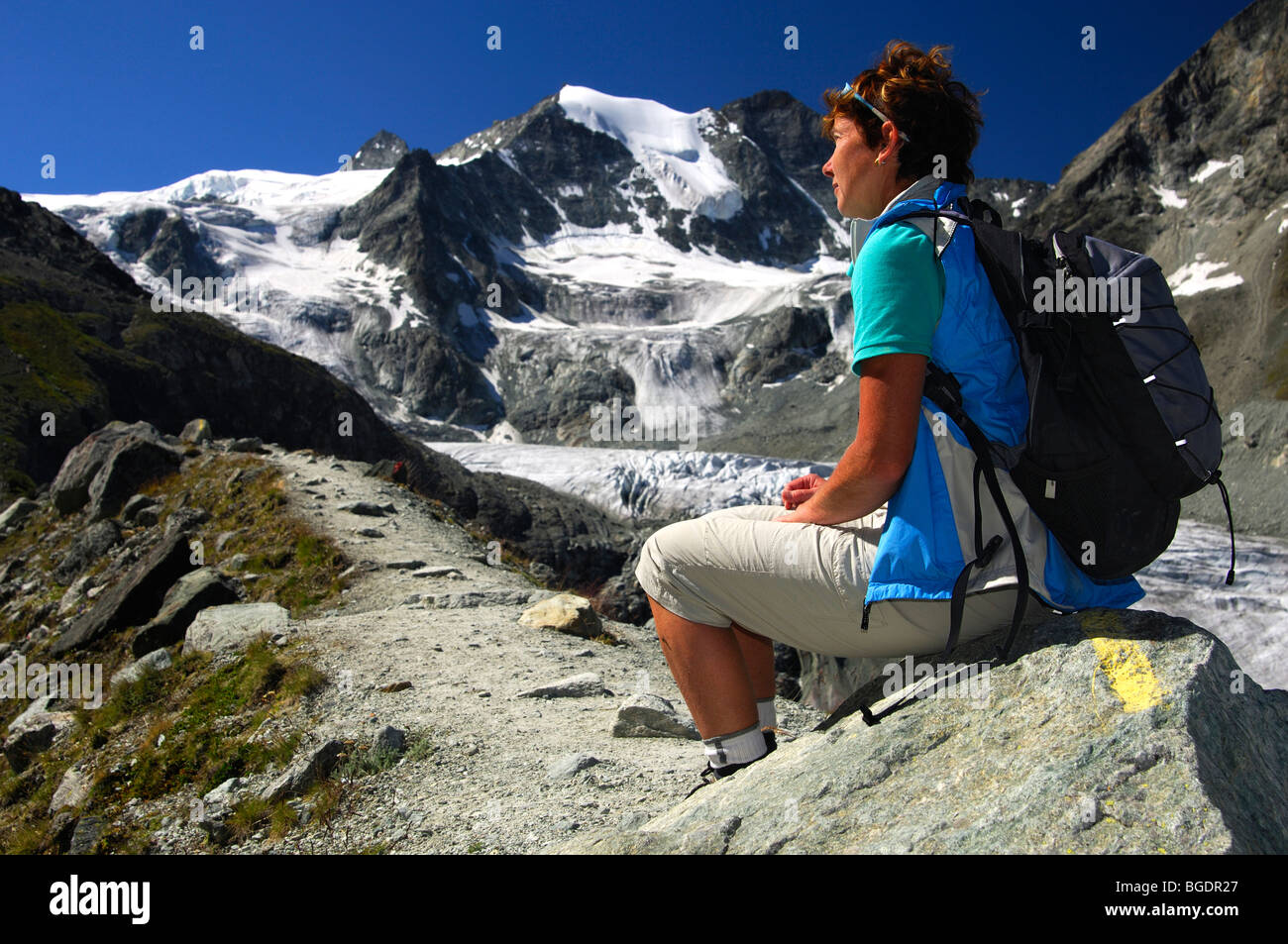 Hiker takes a break during a hiking tour to the Moriy refuge, Mt