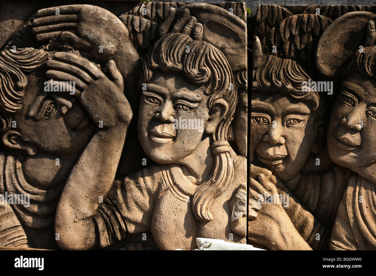 Thai ladies and men carved in stone for a garden, Thailand. Stock Photo