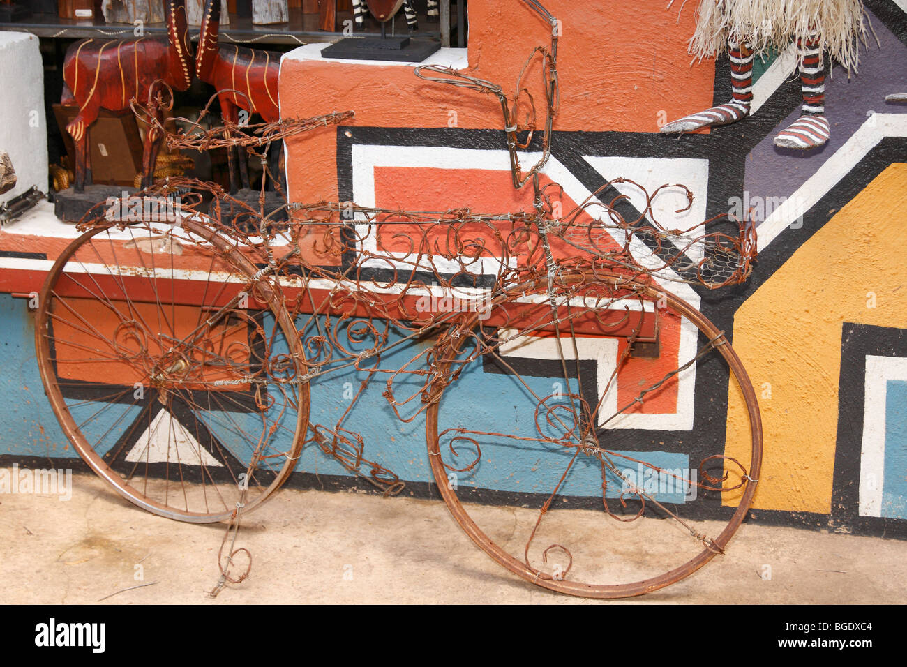 Hand made decorative / artistic bicycle, made of steel wire. Background Ndebele design wall. Lesedi, South Africa, November 2009 Stock Photo