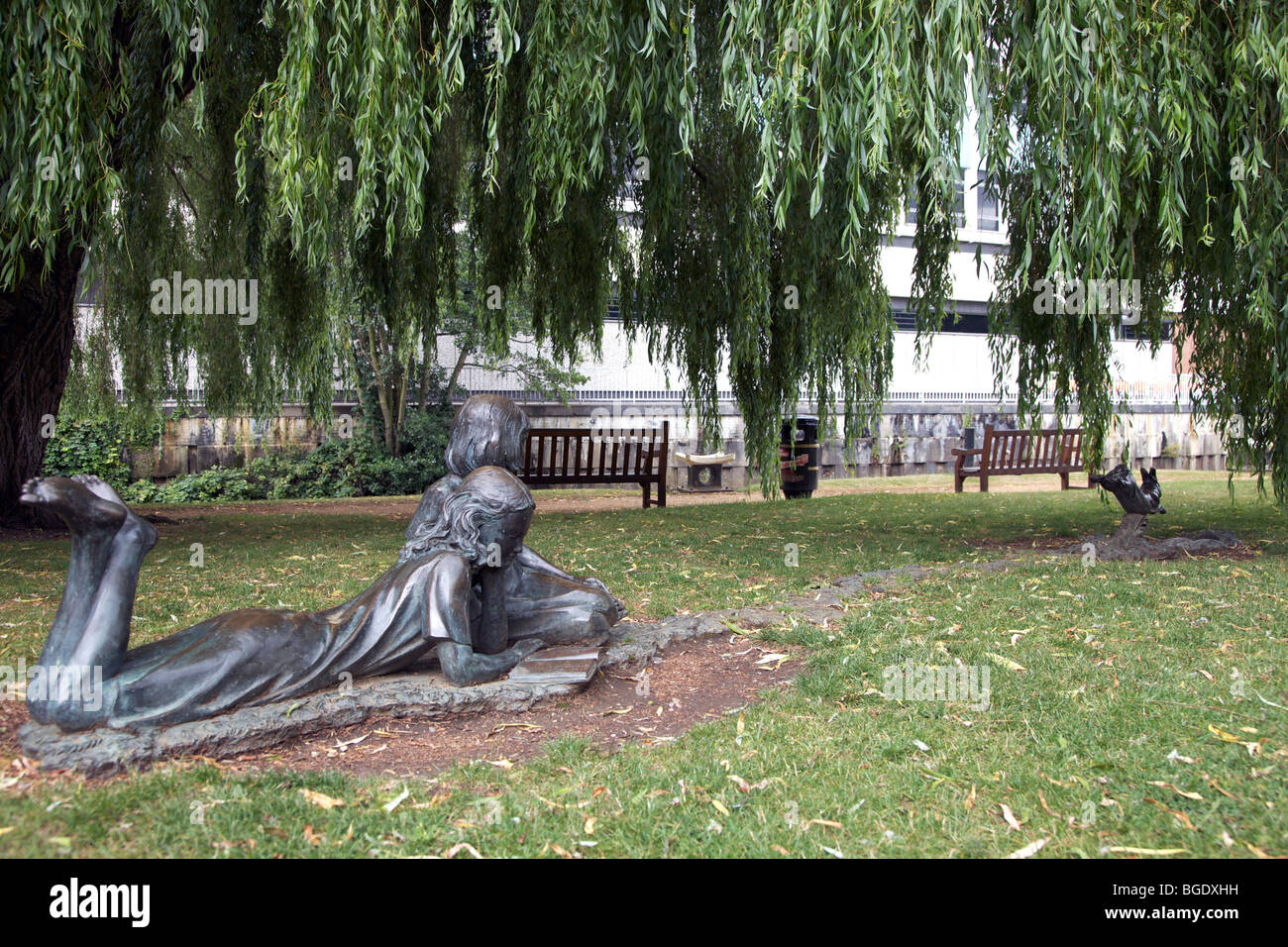 Bronze statue of Alice in Wonderland watching the White Rabbit run for ...