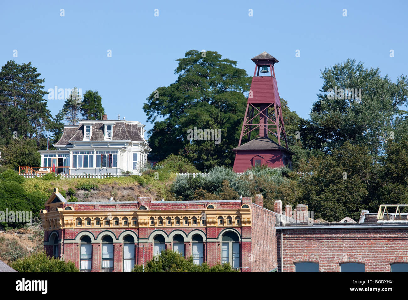 Historic Bell Tower and Victorian buildings on bluff in Port Townsend, WA. Stock Photo