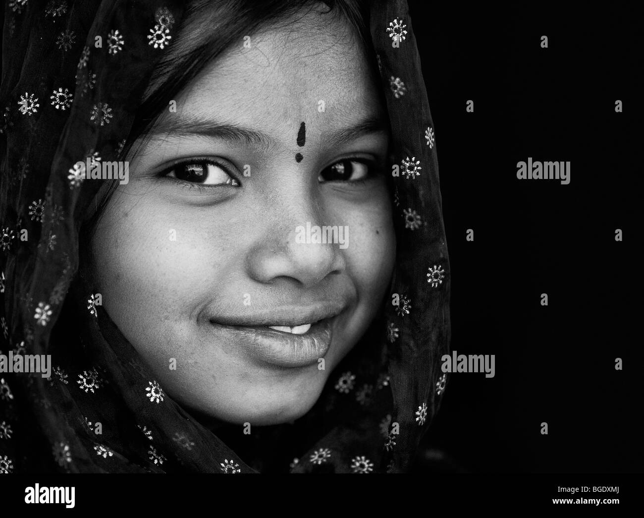 Smiling happy Indian girl wearing a black shawl. Andhra Pradesh, India Stock Photo