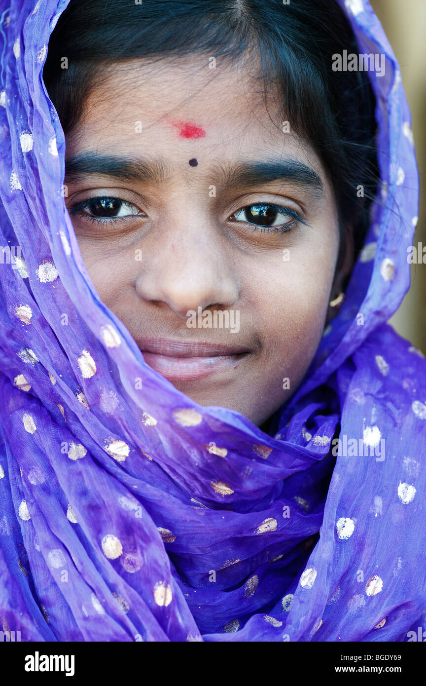 Smiling happy Indian girl wearing a blue/purple shawl Stock Photo
