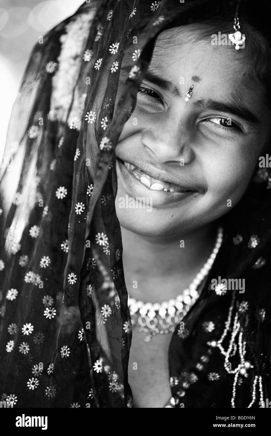 Smiling happy Indian girl wearing a black shawl. Monochrome Stock Photo