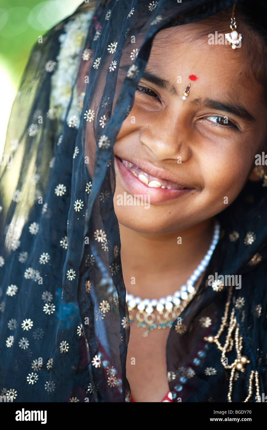 Smiling happy Indian girl wearing a black shawl Stock Photo