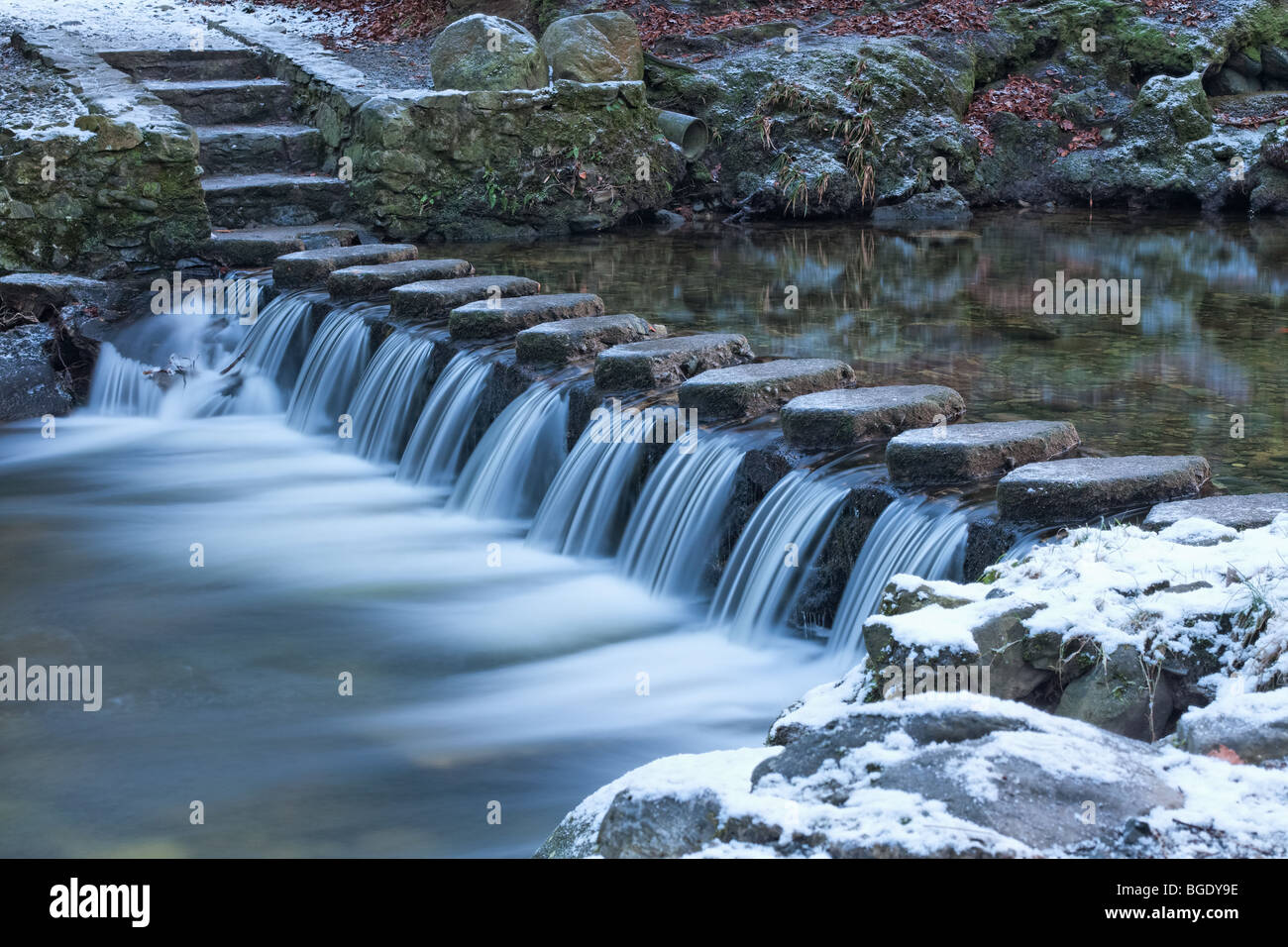 Stepping stones over a river and small waterfall at Tollymore Forest Park in Northern Ireland Stock Photo