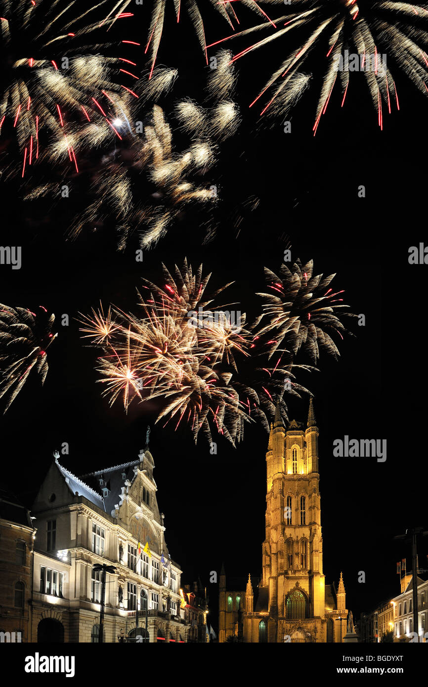Fireworks above the Saint Bavo's Square with theatre and the Saint Bavo's cathedral at night, Ghent, Belgium Stock Photo