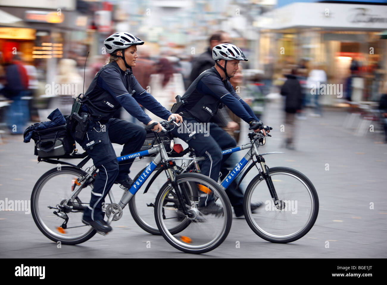 Bicycle patrols in a pedestrian area, Germany, Europe Stock Photo