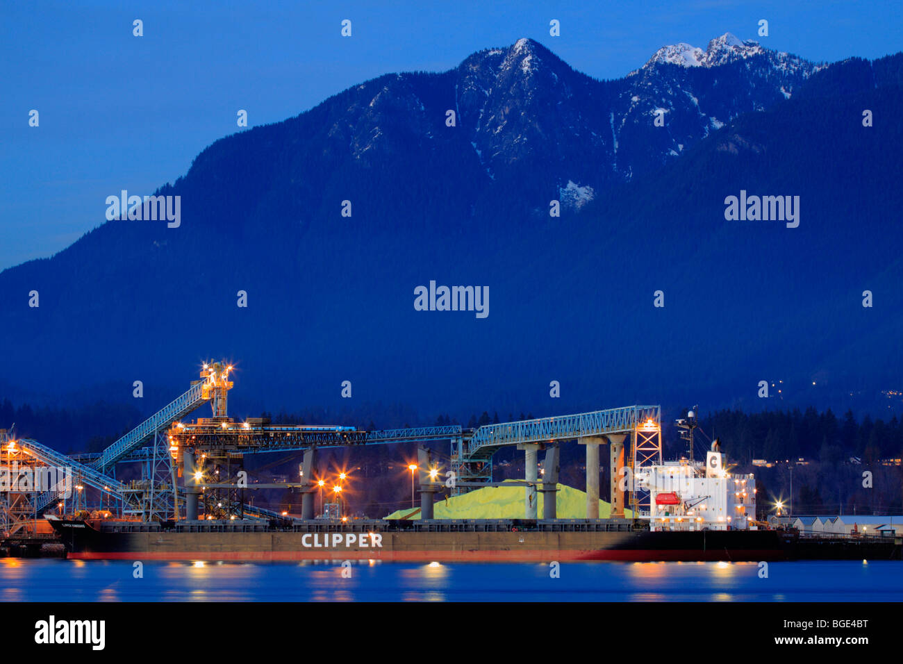 North Shore mountains and sulphur loading port at dusk-Vancouver, British Columbia, Canada. Stock Photo