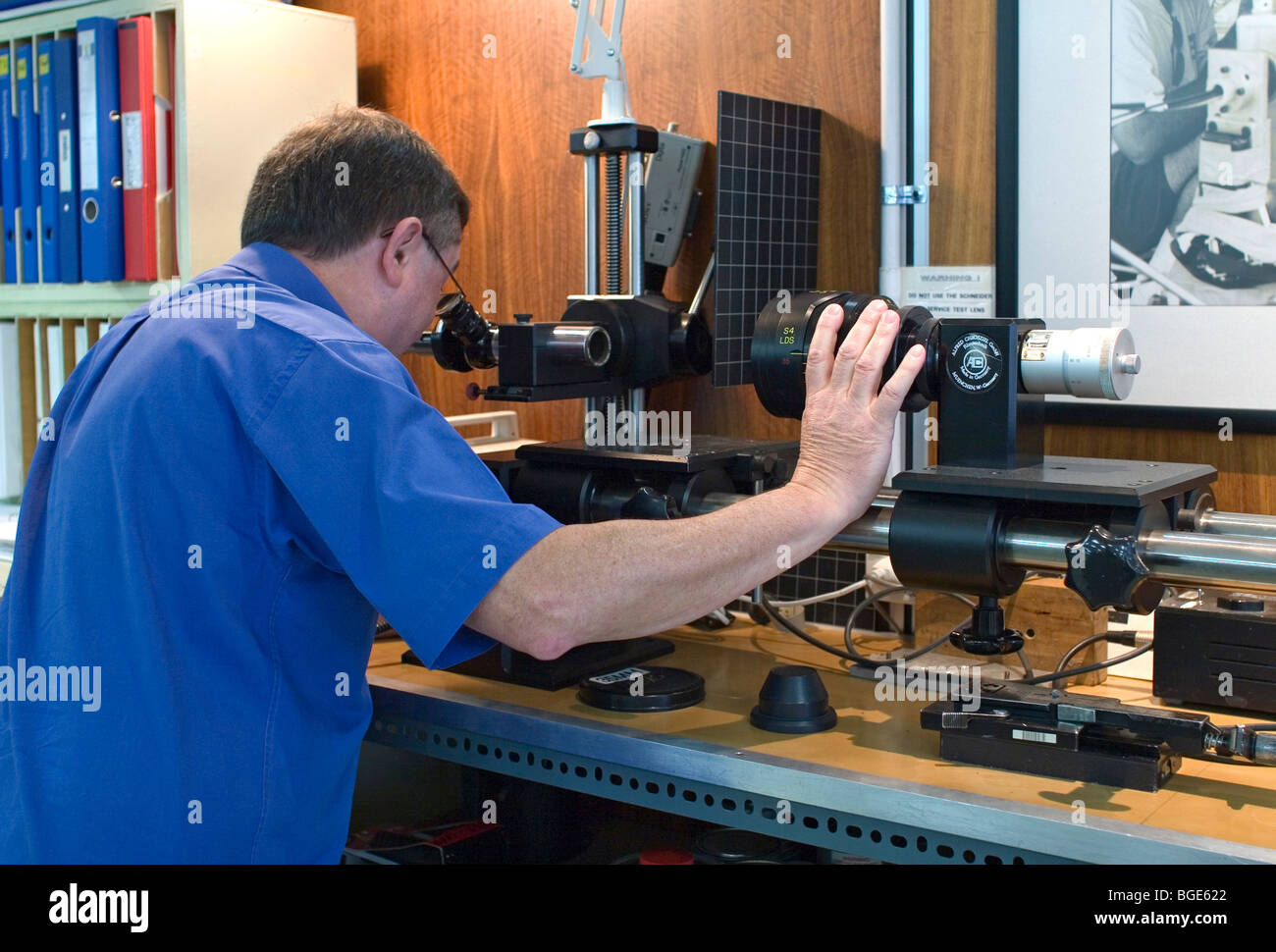 Lens Technician checking a lens on an Autocollimator Stock Photo Alamy