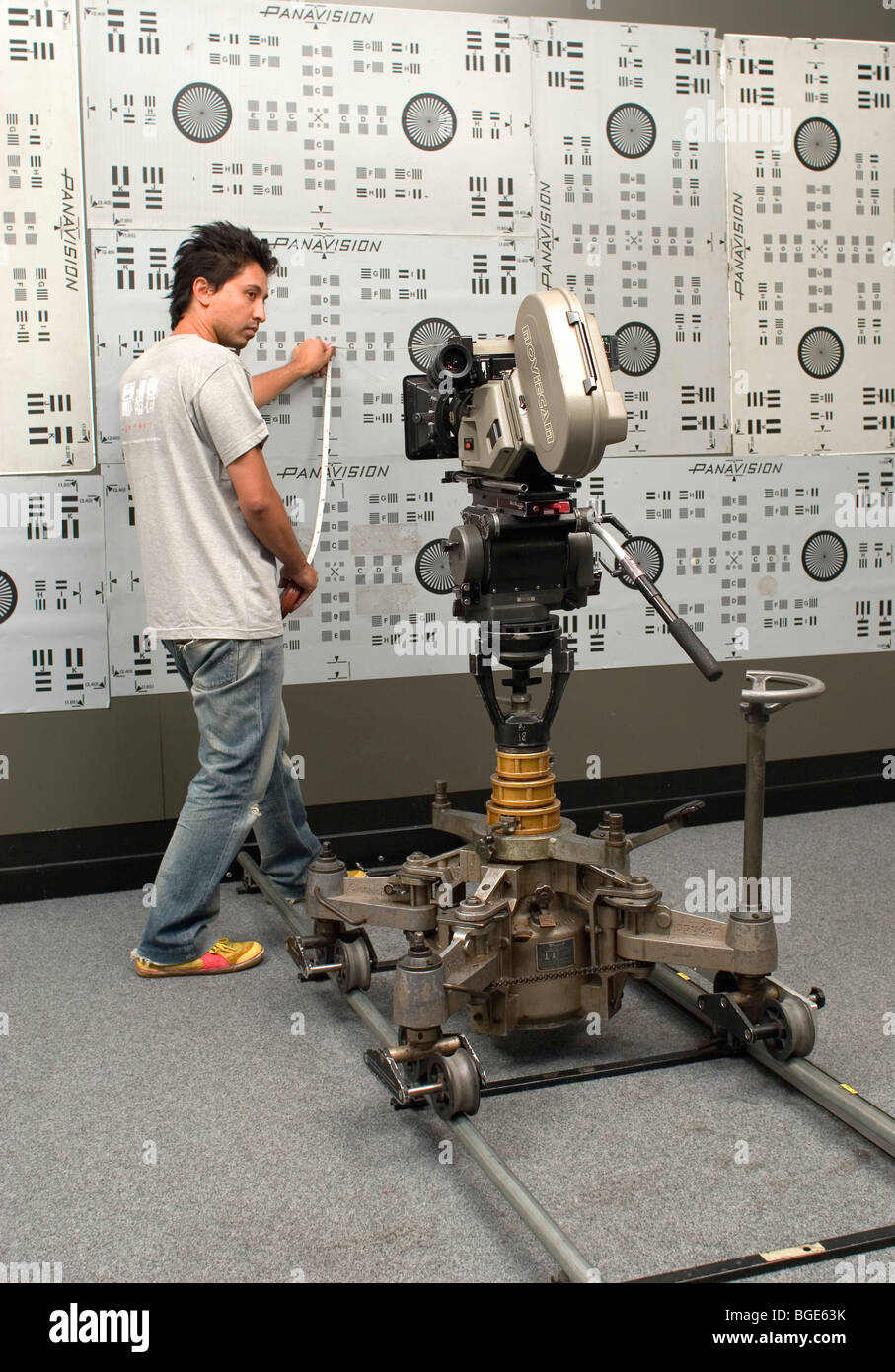 A Focus Puller (assistant cameraman) using a movie camera (motion