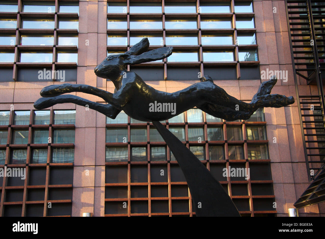 Supported by his vertical crescent is the Leaping Hare by the late Barry Flanagan, situated at Broadgate Circus. Stock Photo
