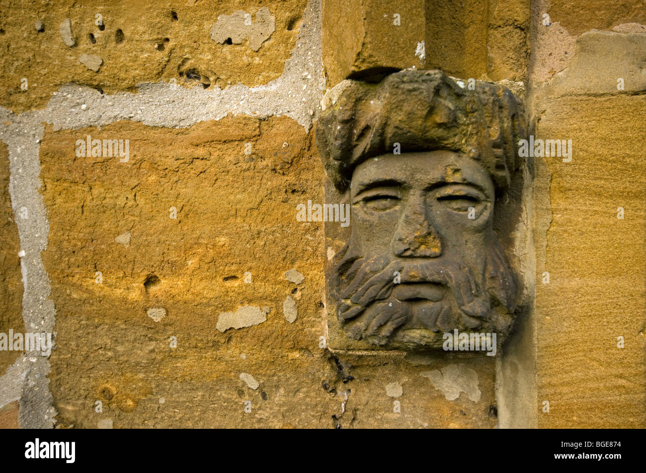 A carved stone face on Abington Church,Northampton Stock Photo