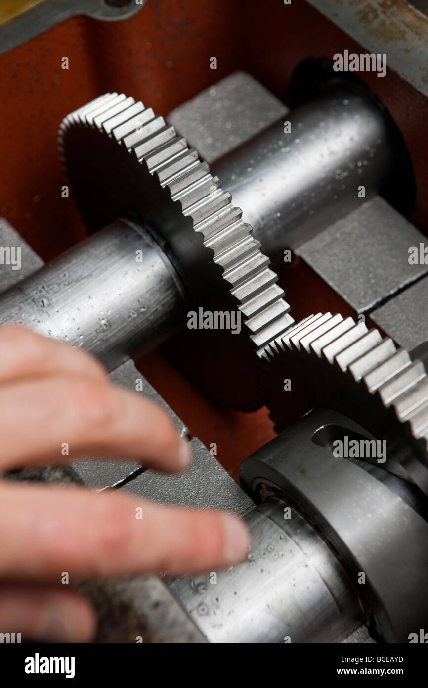 A hand approaching a gearbox. Stock Photo