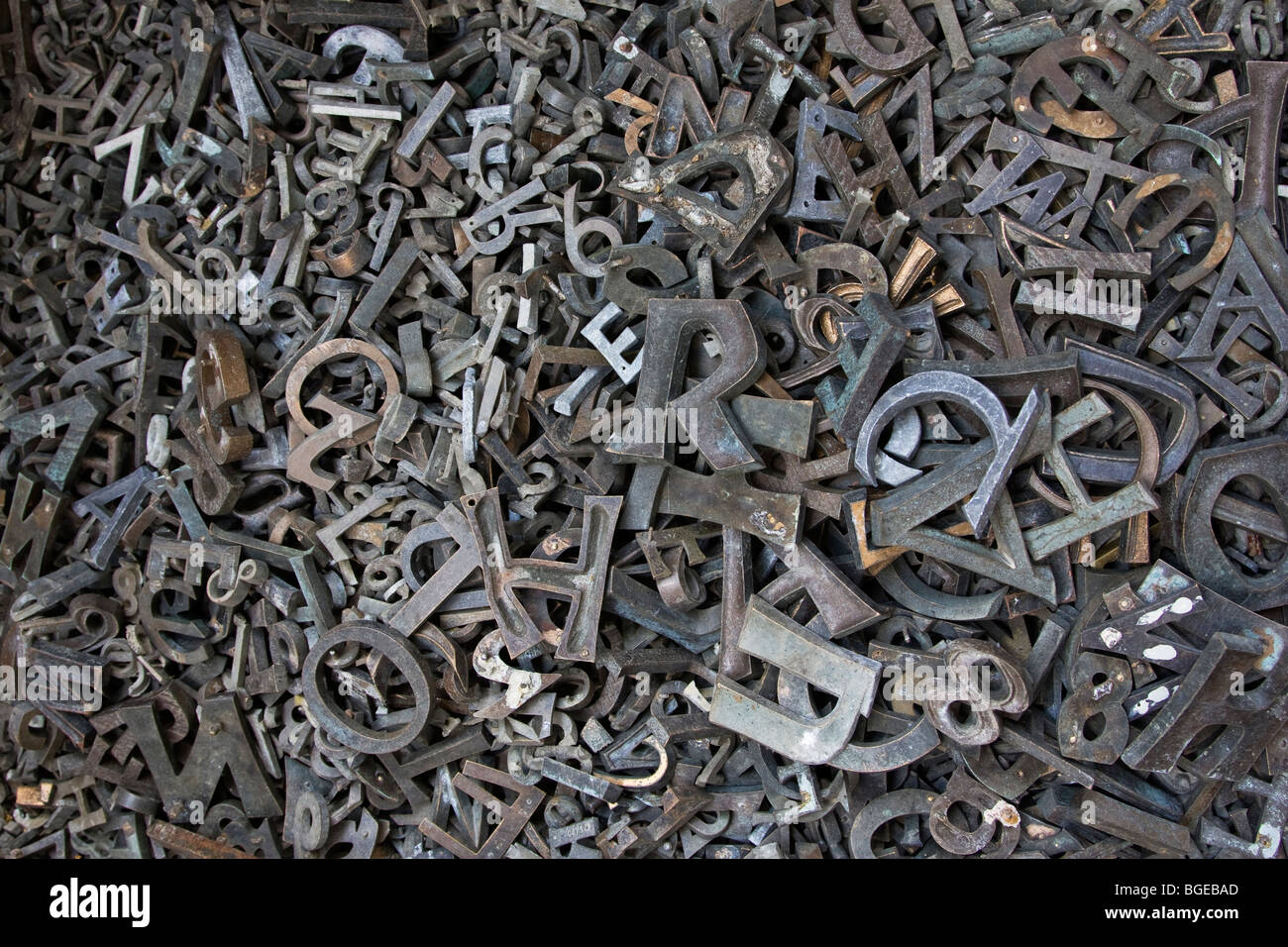 Stamped metal letters in a pile. Stock Photo