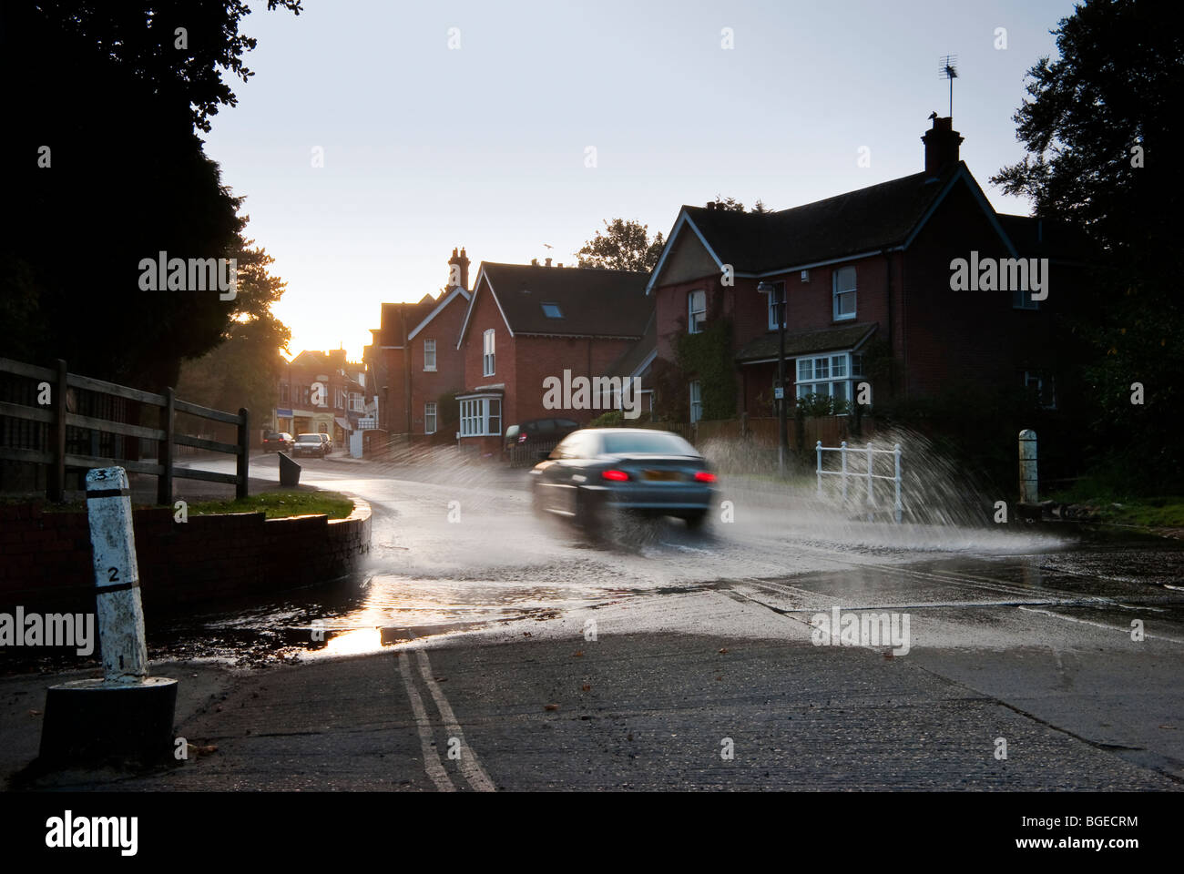 Car driving through the watersplash at Brockenhurst, in the New Forest early morning Stock Photo